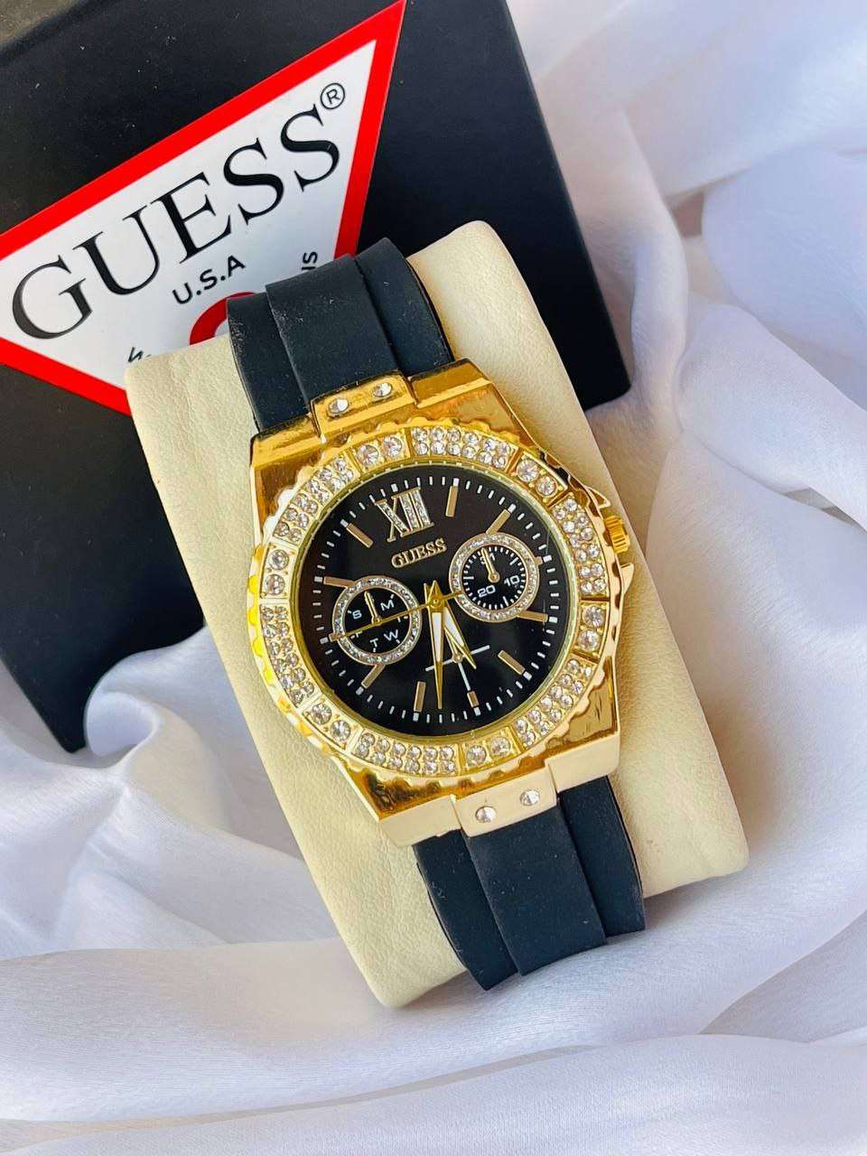 ساعة Guess Women’s Black Rubber Strap – Gold Crystal Bezel 